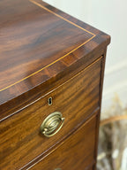 Wooden dresser with brass handle and keyhole on a blurred background
