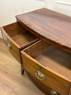 Wooden dresser with open drawer on a wooden floor