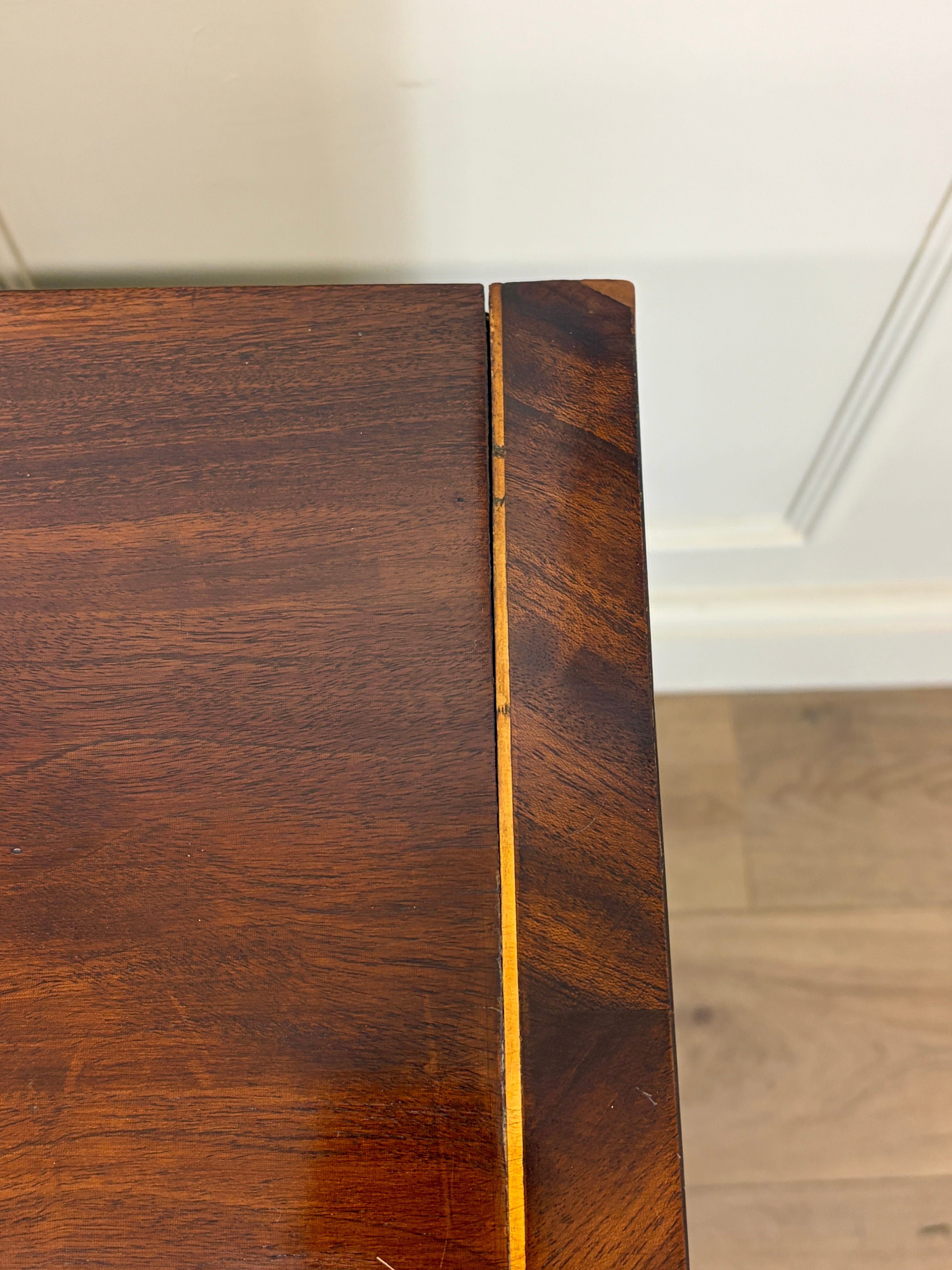 Close-up of a wooden surface with a visible grain pattern.