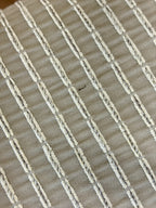 Close-up of a woven fabric with horizontal stripes in beige and white.