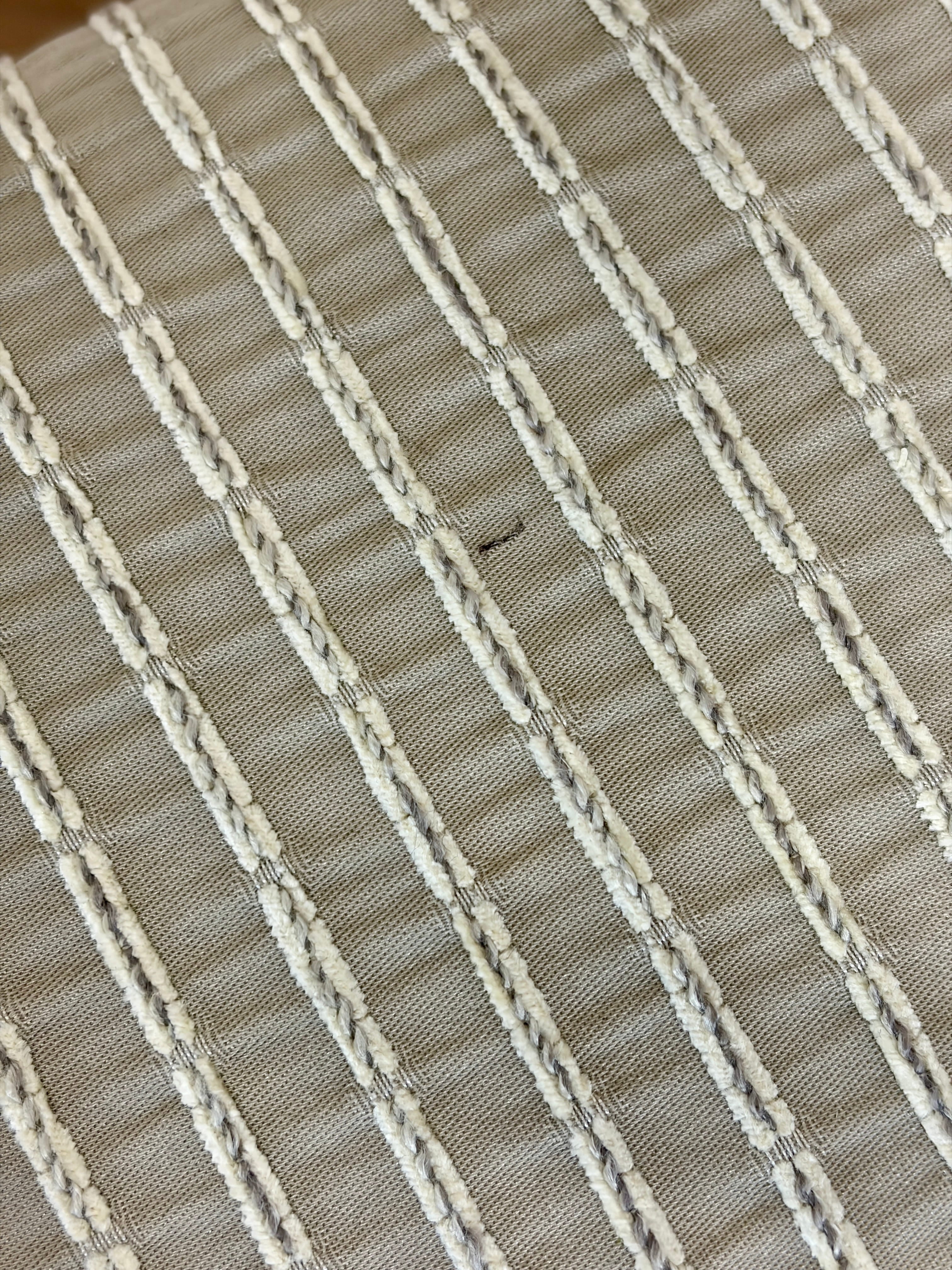 Close-up of a woven fabric with horizontal stripes in beige and white.