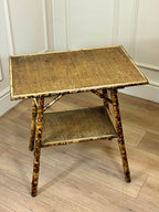 Tortoiseshell side table with wicker design on a wooden floor.