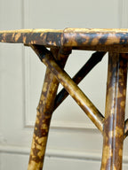 Close-up of a rattan table with a textured surface against a neutral background