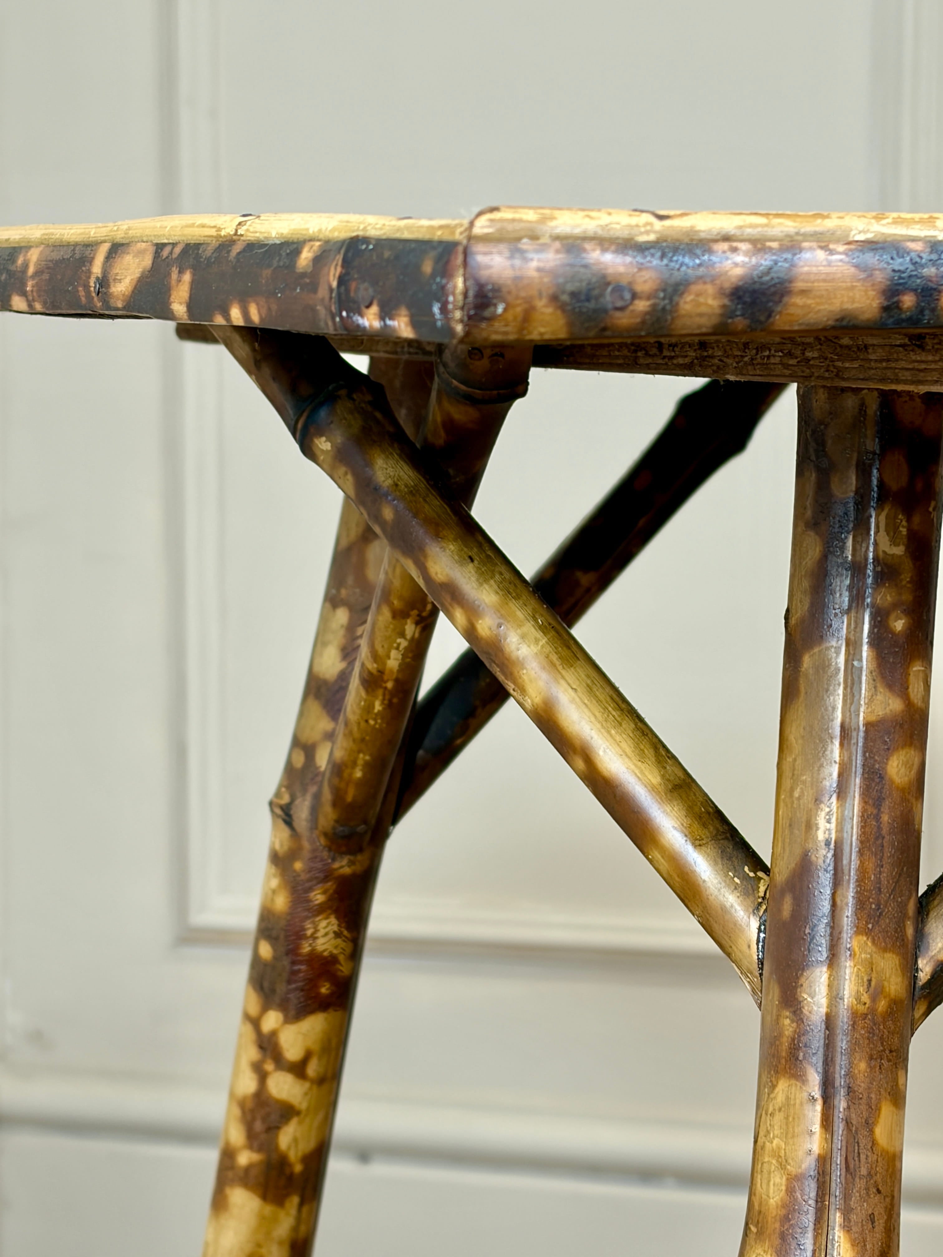 Close-up of a rattan table with a textured surface against a neutral background