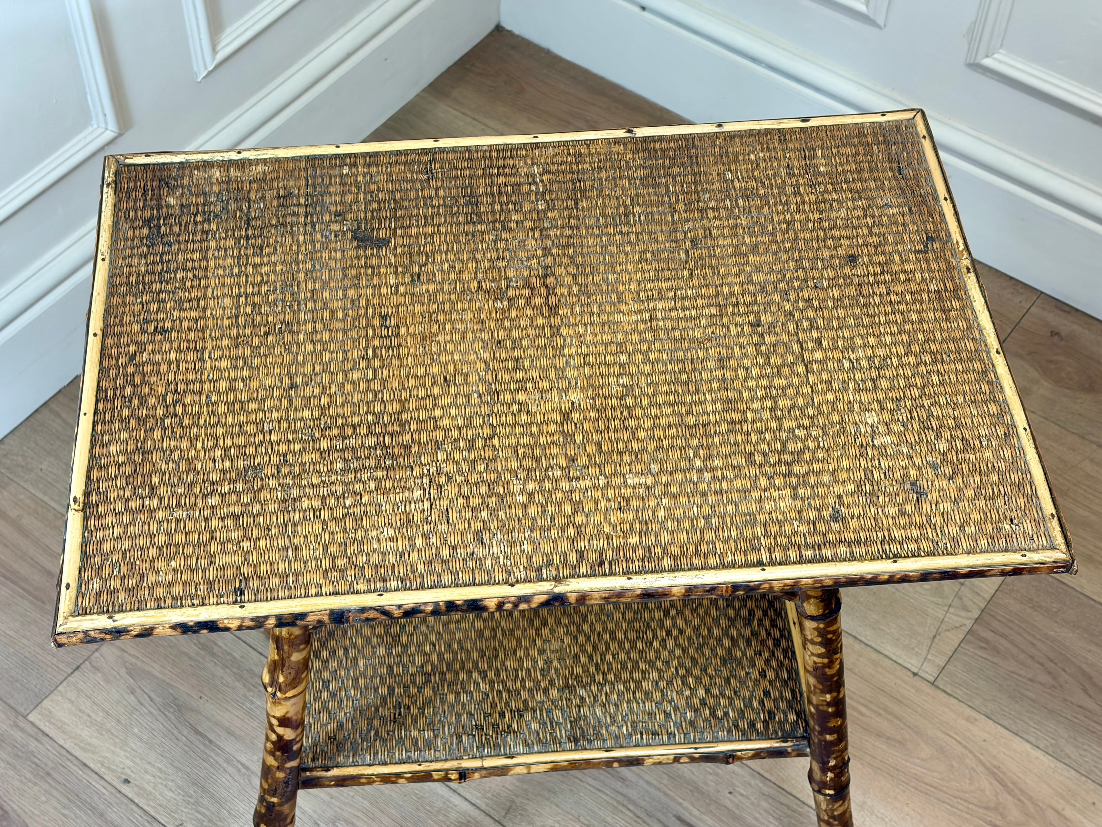 Wicker coffee table with a worn surface on a wooden floor.