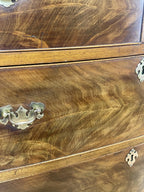 Close-up of a wooden cabinet with brass handles