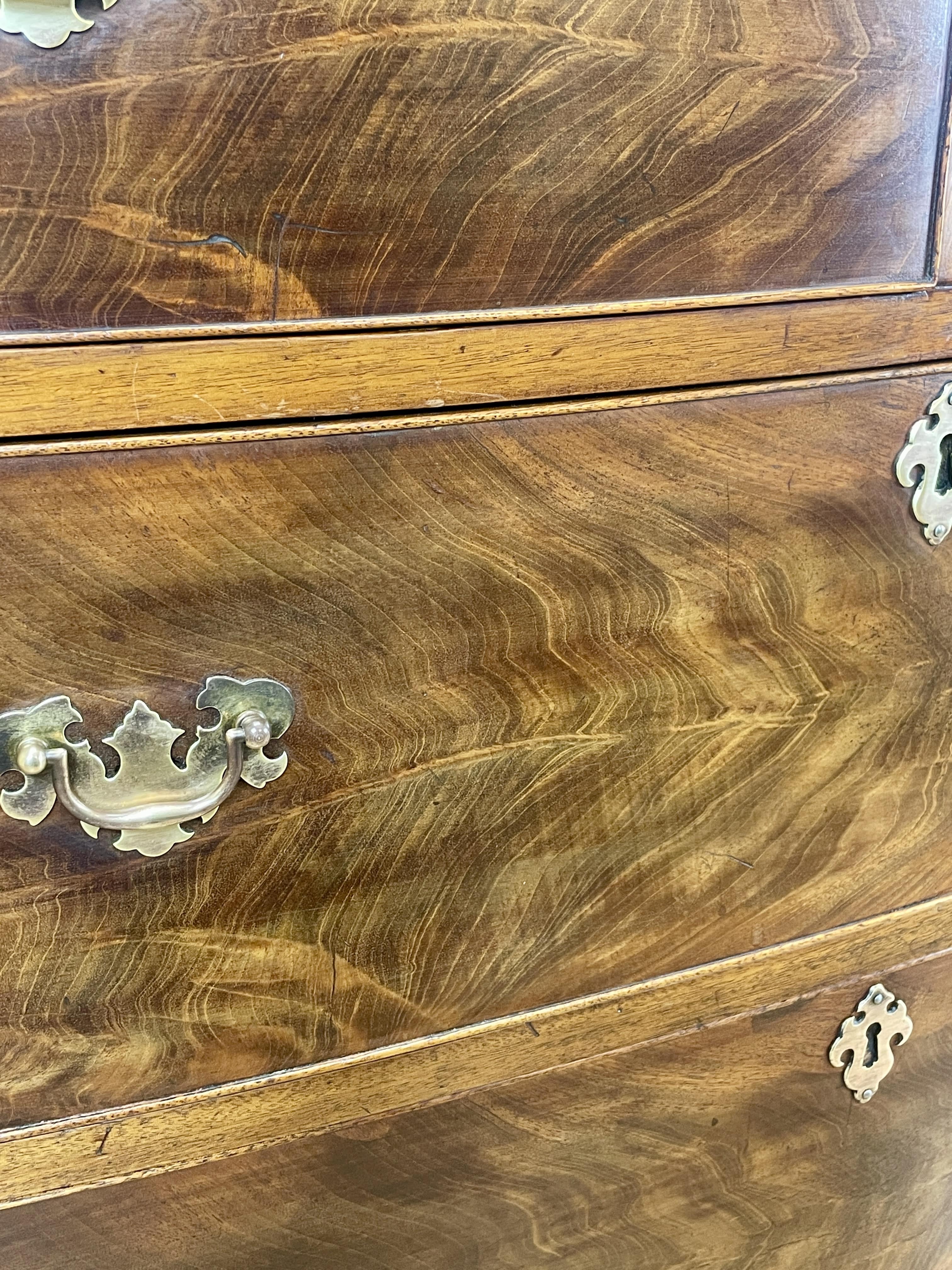 Close-up of a wooden cabinet with brass handles