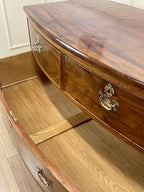Wooden dresser with two drawers and a cabinet door, featuring metal handles.