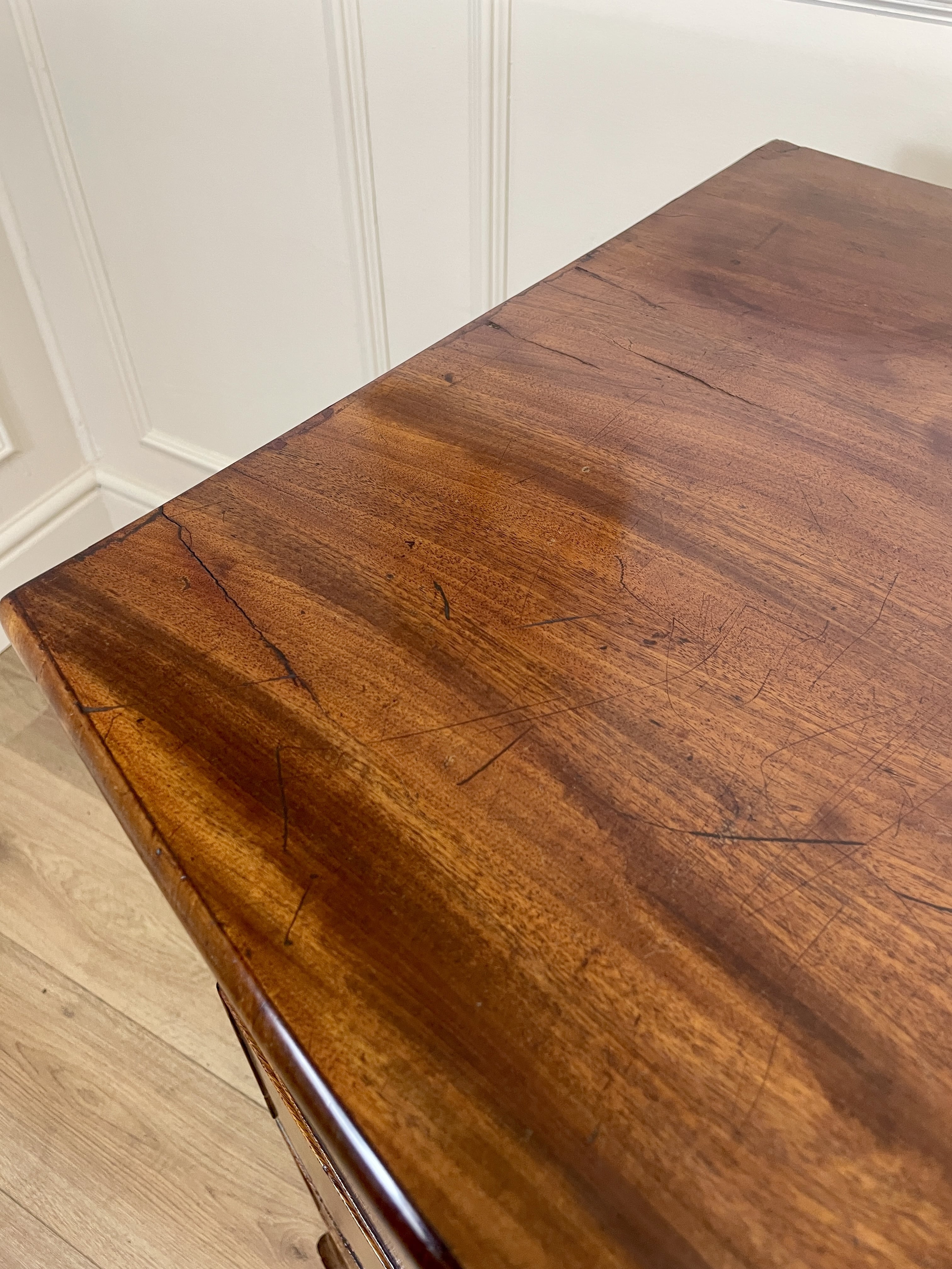 Wooden table with a white wall background