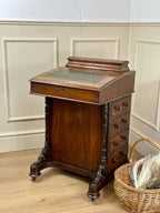 Antique Victorian Burr Walnut Davenport Writing Desk with original dark green leather top, boxwood stringing, side drawers, and turned columns on castors.