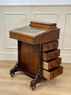 Antique Victorian Burr Walnut Davenport Writing Desk with original dark green leather top, boxwood stringing, side drawers, and turned columns on castors.