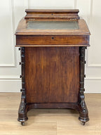 Antique Victorian Burr Walnut Davenport Writing Desk with original dark green leather top, boxwood stringing, side drawers, and turned columns on castors.