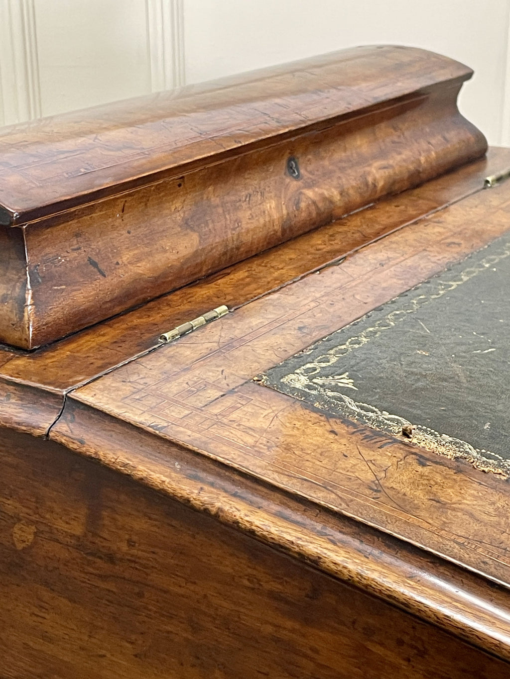 Antique Victorian Burr Walnut Davenport Writing Desk with original dark green leather top, boxwood stringing, side drawers, and turned columns on castors.
