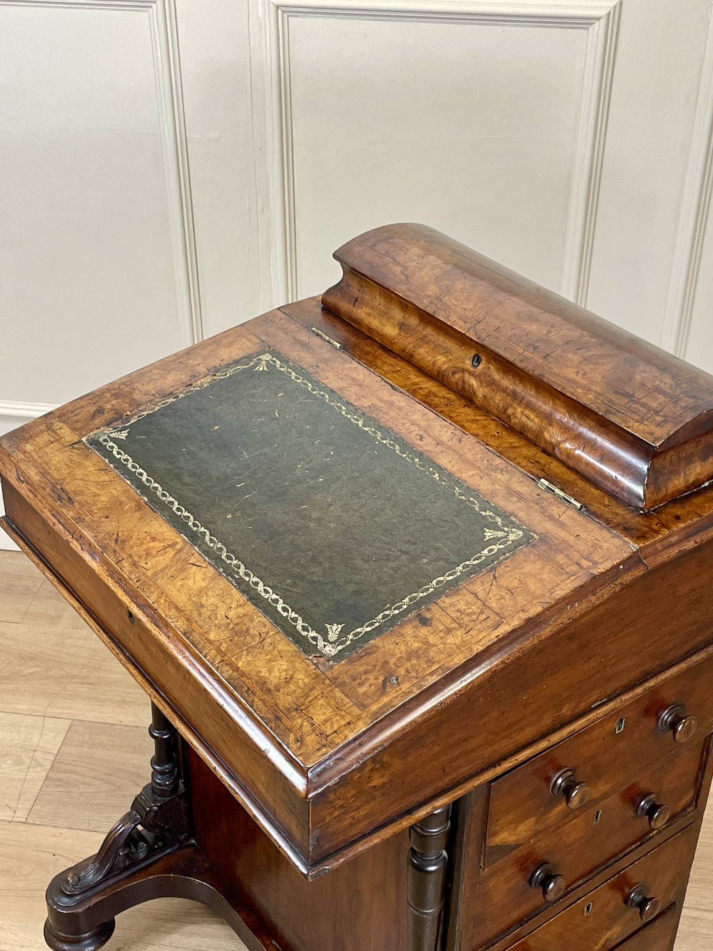 Antique Victorian Burr Walnut Davenport Writing Desk with original dark green leather top, boxwood stringing, side drawers, and turned columns on castors.