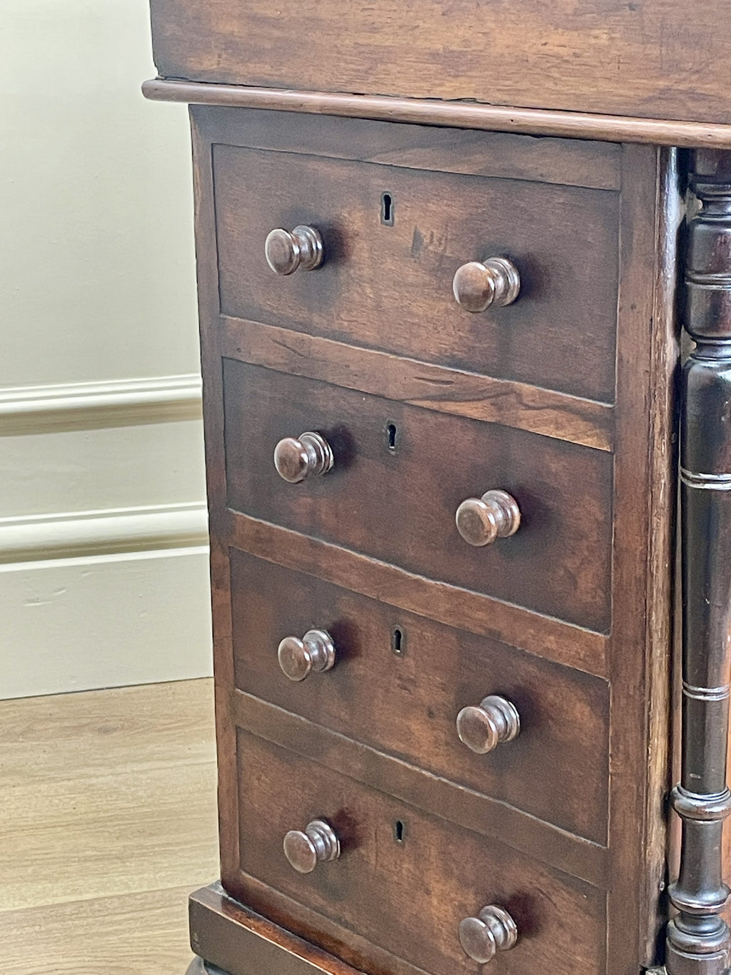 Antique Victorian Burr Walnut Davenport Writing Desk with original dark green leather top, boxwood stringing, side drawers, and turned columns on castors.