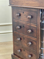 Antique Victorian Burr Walnut Davenport Writing Desk with original dark green leather top, boxwood stringing, side drawers, and turned columns on castors.