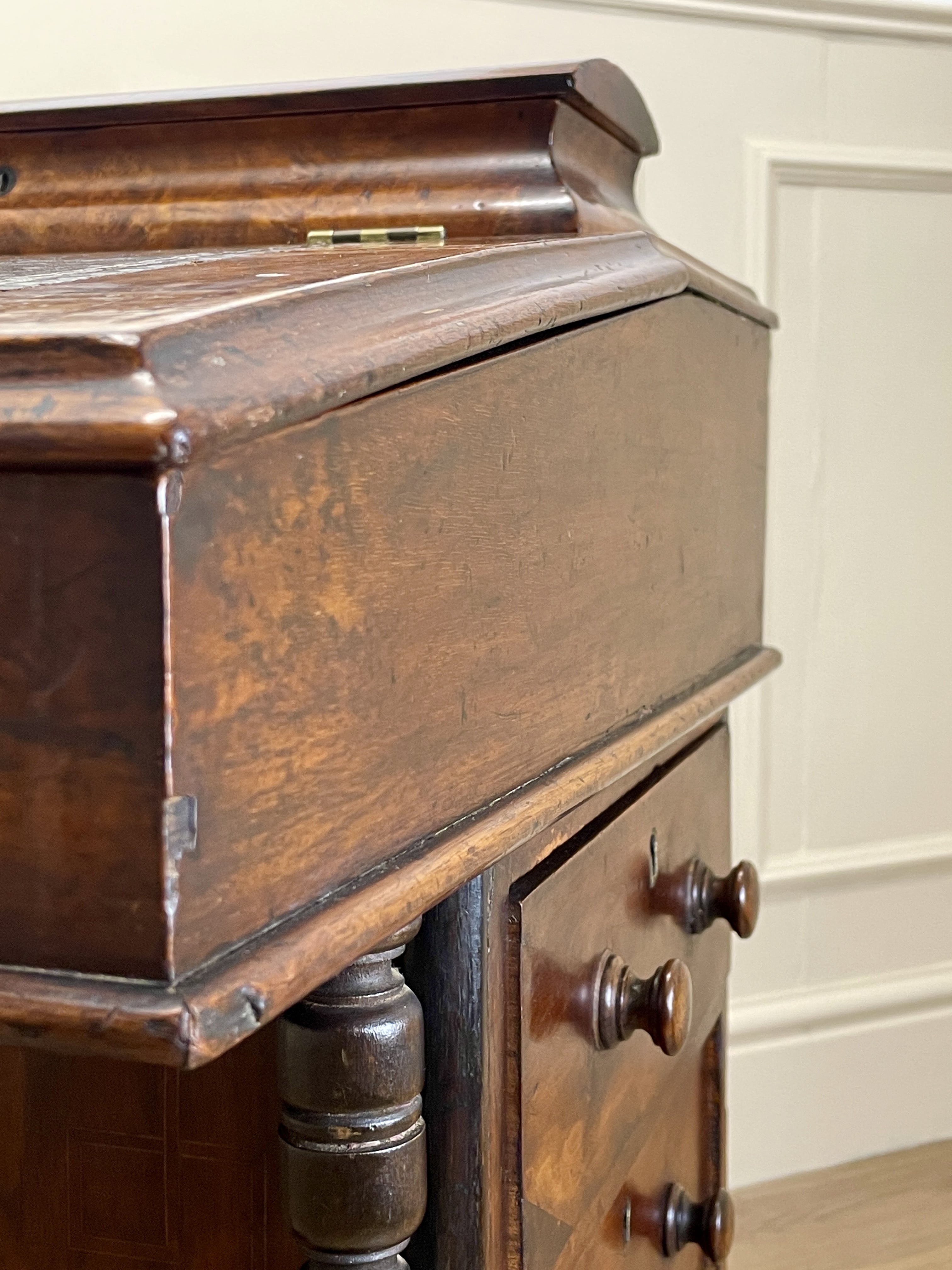 Antique Victorian Burr Walnut Davenport Writing Desk with original dark green leather top, boxwood stringing, side drawers, and turned columns on castors.