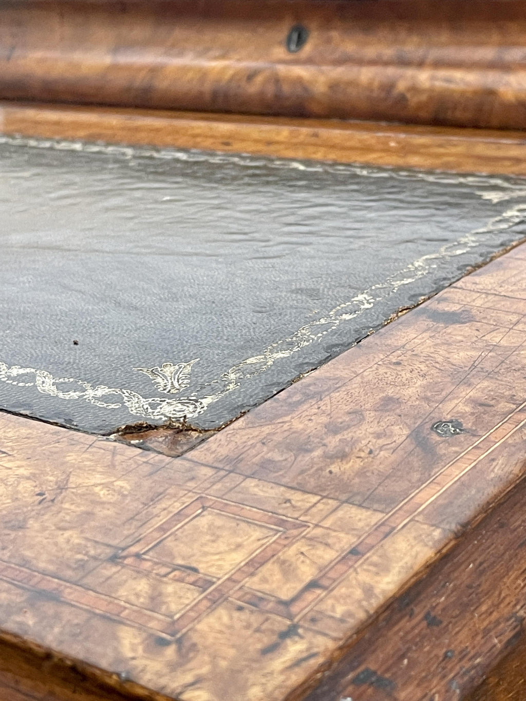 Antique Victorian Burr Walnut Davenport Writing Desk with original dark green leather top, boxwood stringing, side drawers, and turned columns on castors.