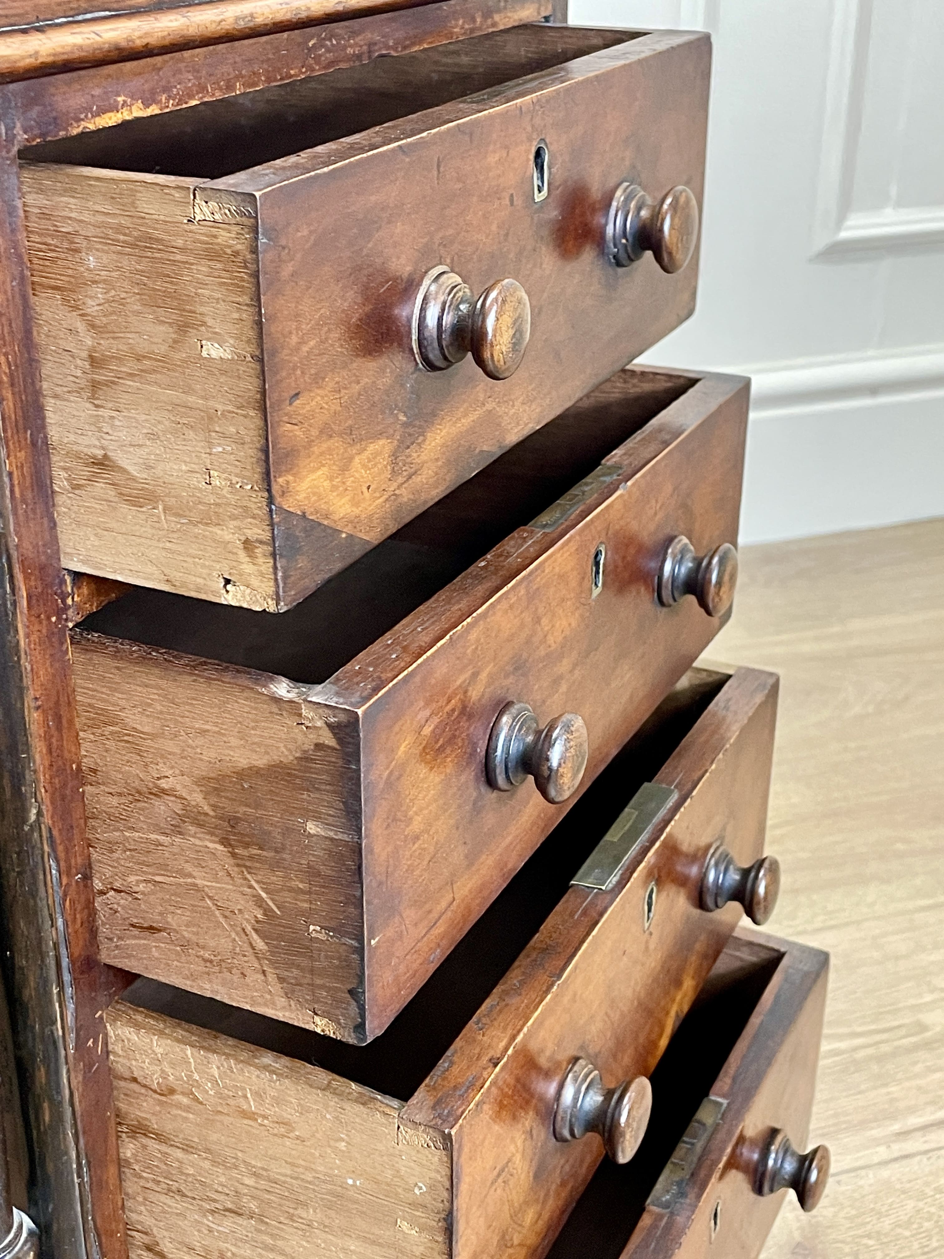 Antique Victorian Burr Walnut Davenport Writing Desk with original dark green leather top, boxwood stringing, side drawers, and turned columns on castors.