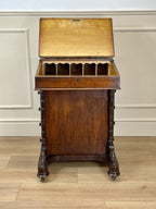 Antique Victorian Burr Walnut Davenport Writing Desk with original dark green leather top, boxwood stringing, side drawers, and turned columns on castors.