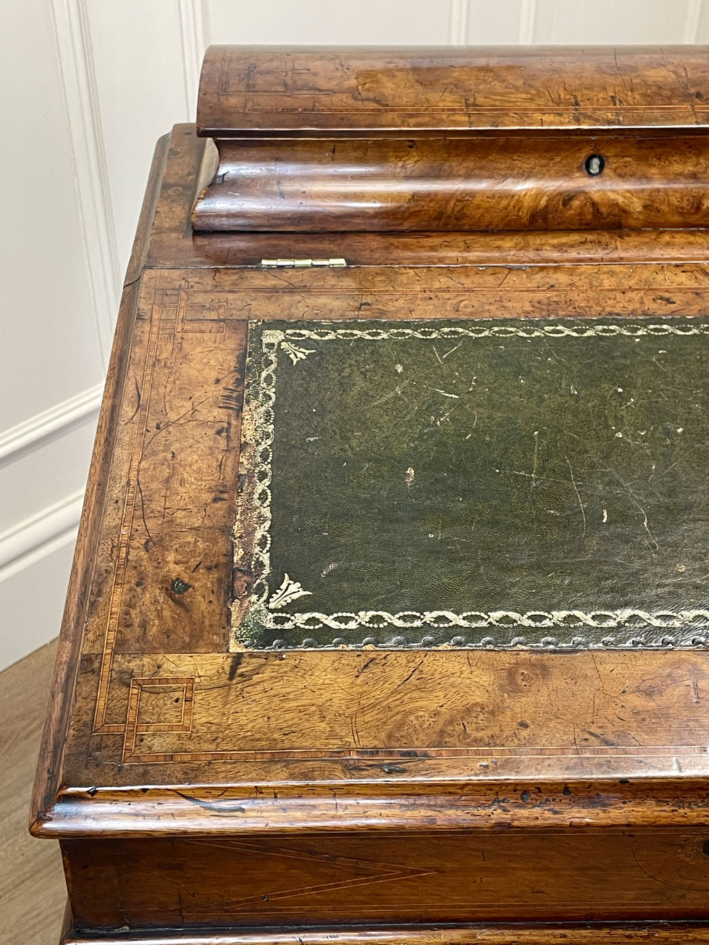 Antique Victorian Burr Walnut Davenport Writing Desk with original dark green leather top, boxwood stringing, side drawers, and turned columns on castors.