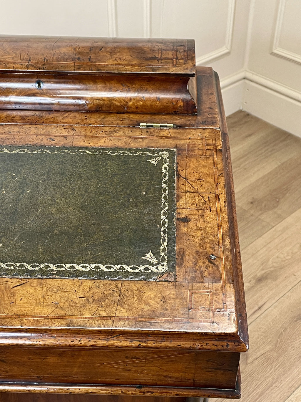 Antique Victorian Burr Walnut Davenport Writing Desk with original dark green leather top, boxwood stringing, side drawers, and turned columns on castors.