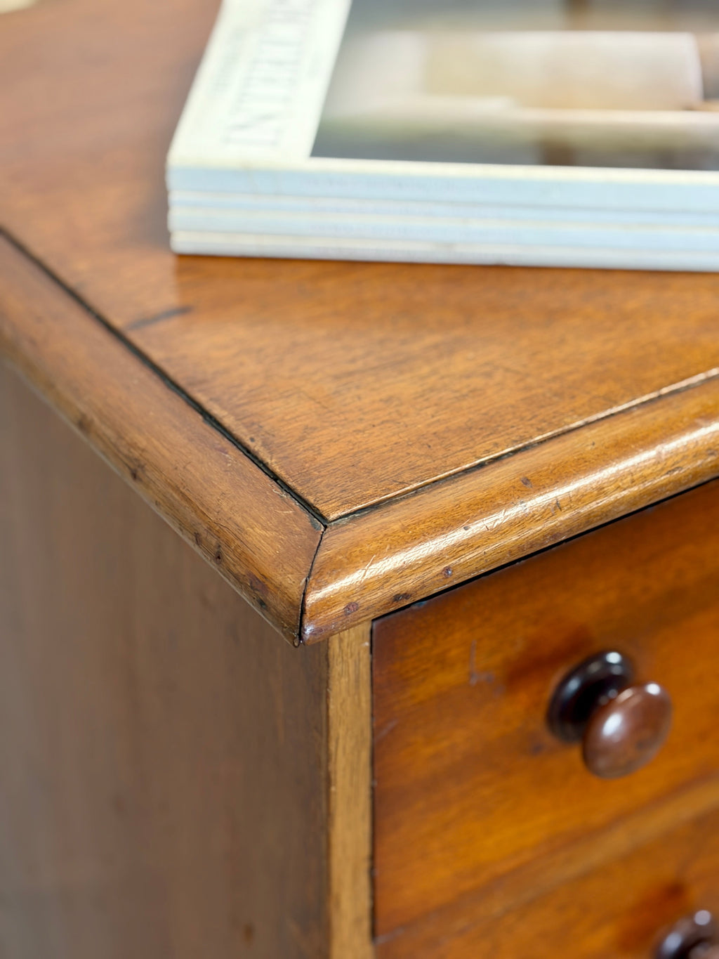 Wooden jewelry box with a drawer open, revealing items inside.