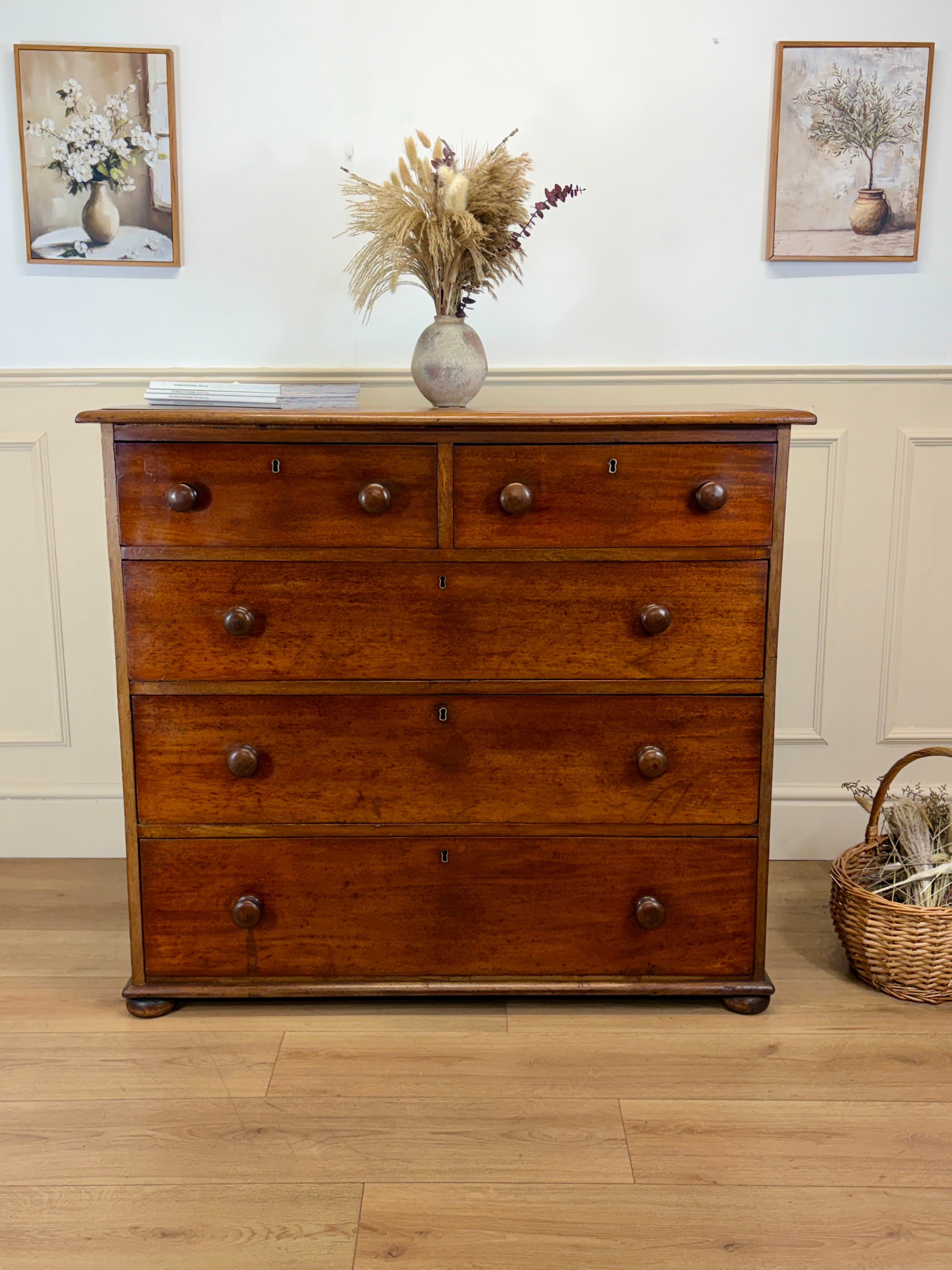 Wooden dresser with decorative items on a wooden floor