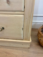 Wooden cabinet with a wicker basket on a wooden floor