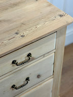 Wooden dresser with two drawers and metal handles on a wooden floor.