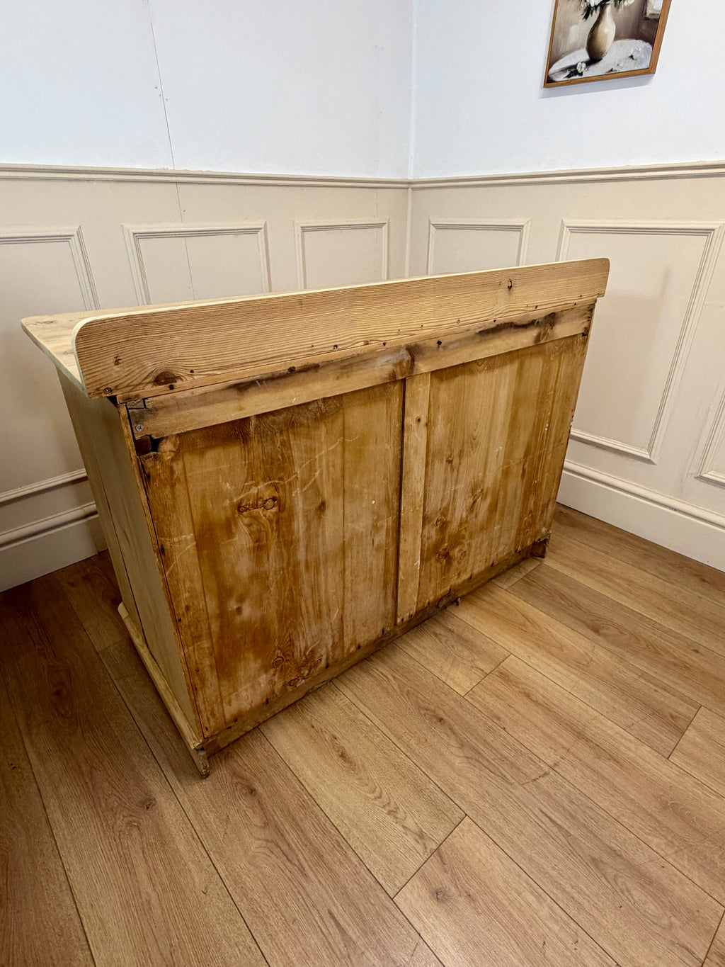 Wooden cabinet against a white paneled wall