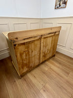Wooden cabinet against a white paneled wall