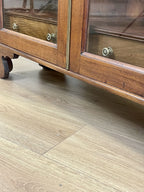 Wooden cabinet with glass doors on a wooden floor