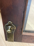 Wooden door with a brass doorknob and lock mechanism.