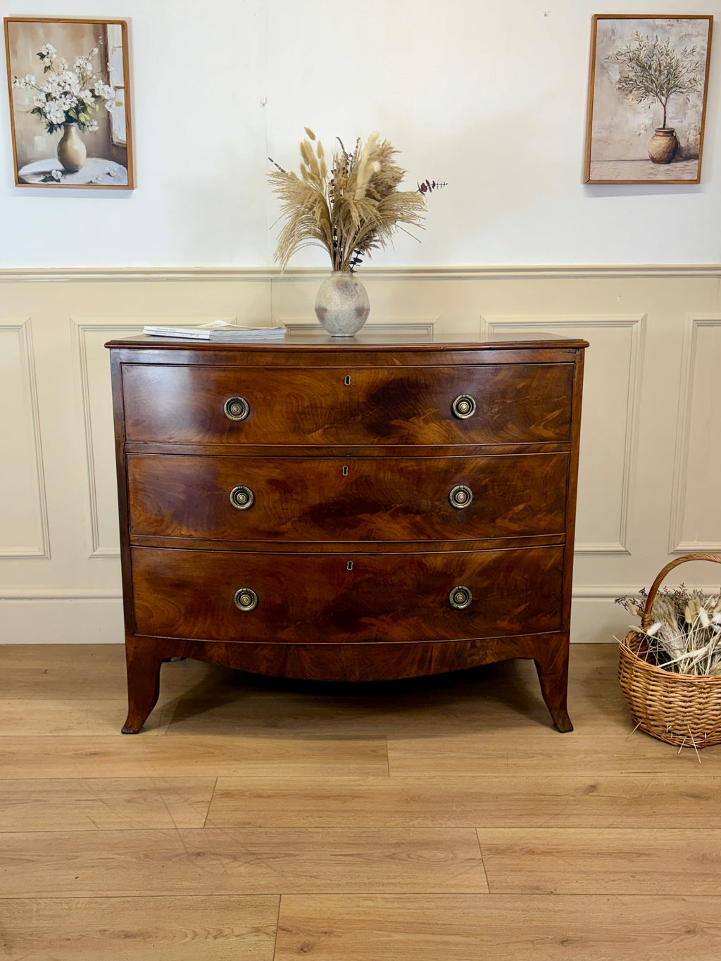 Wooden dresser with decorative items on a wooden floor and wall.