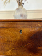 Wooden chest with a mirror above it