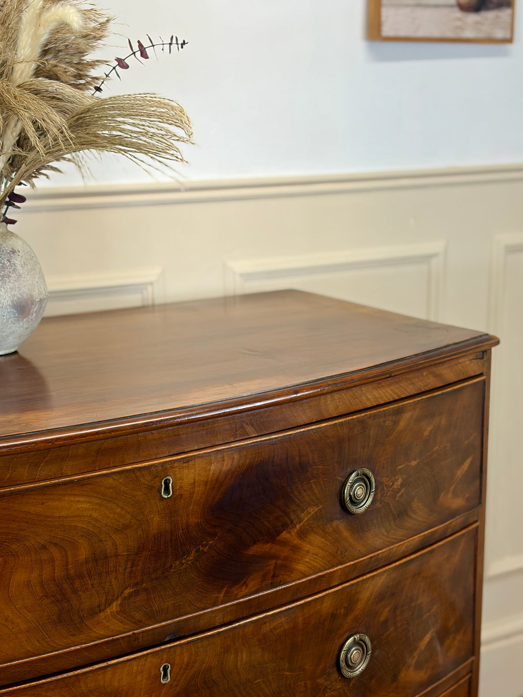 Wooden dresser with decorative elements on a wall