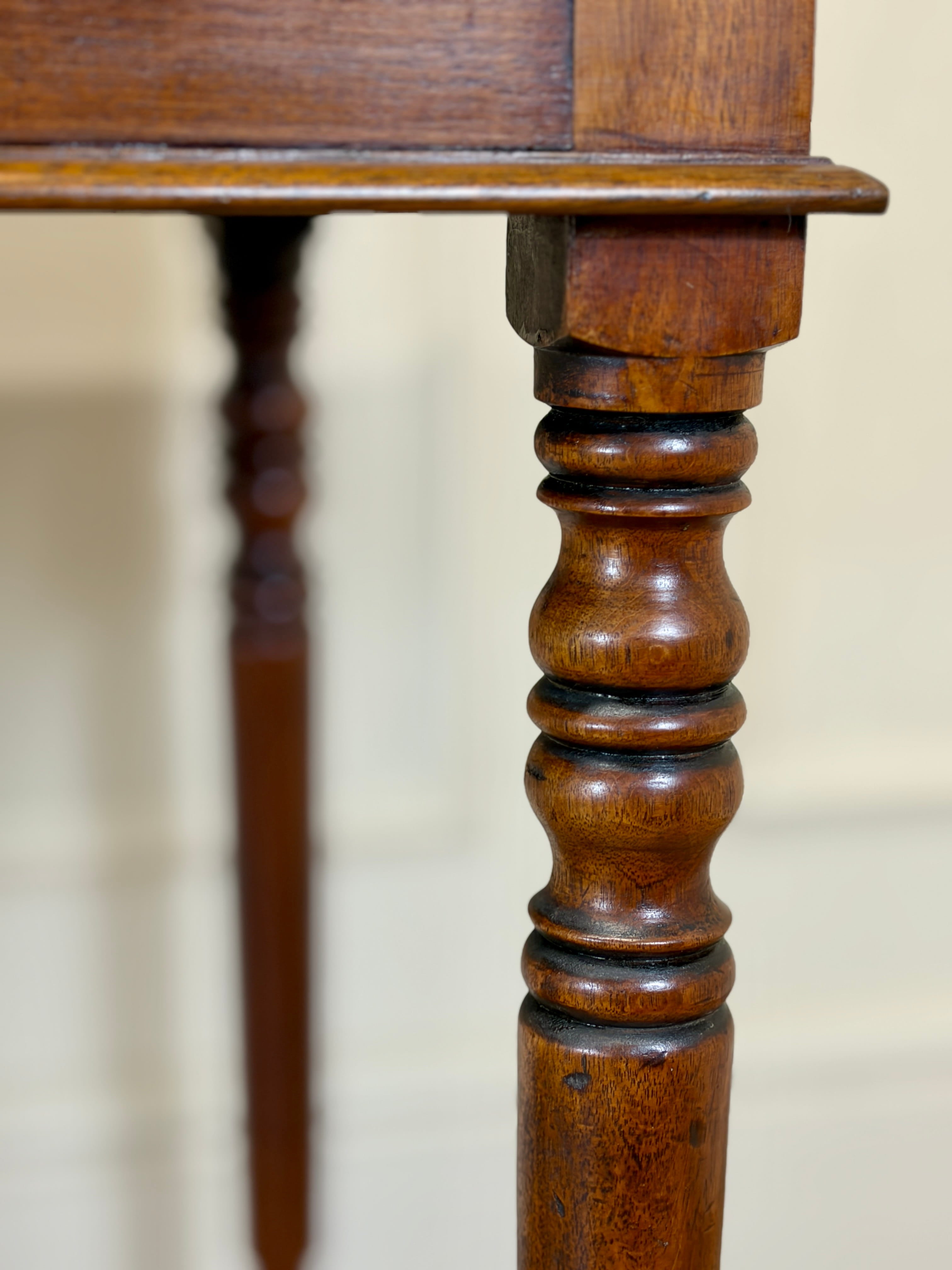 Close-up of a wooden table leg with intricate design