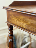Close-up of a wooden sideboard with a blurred background