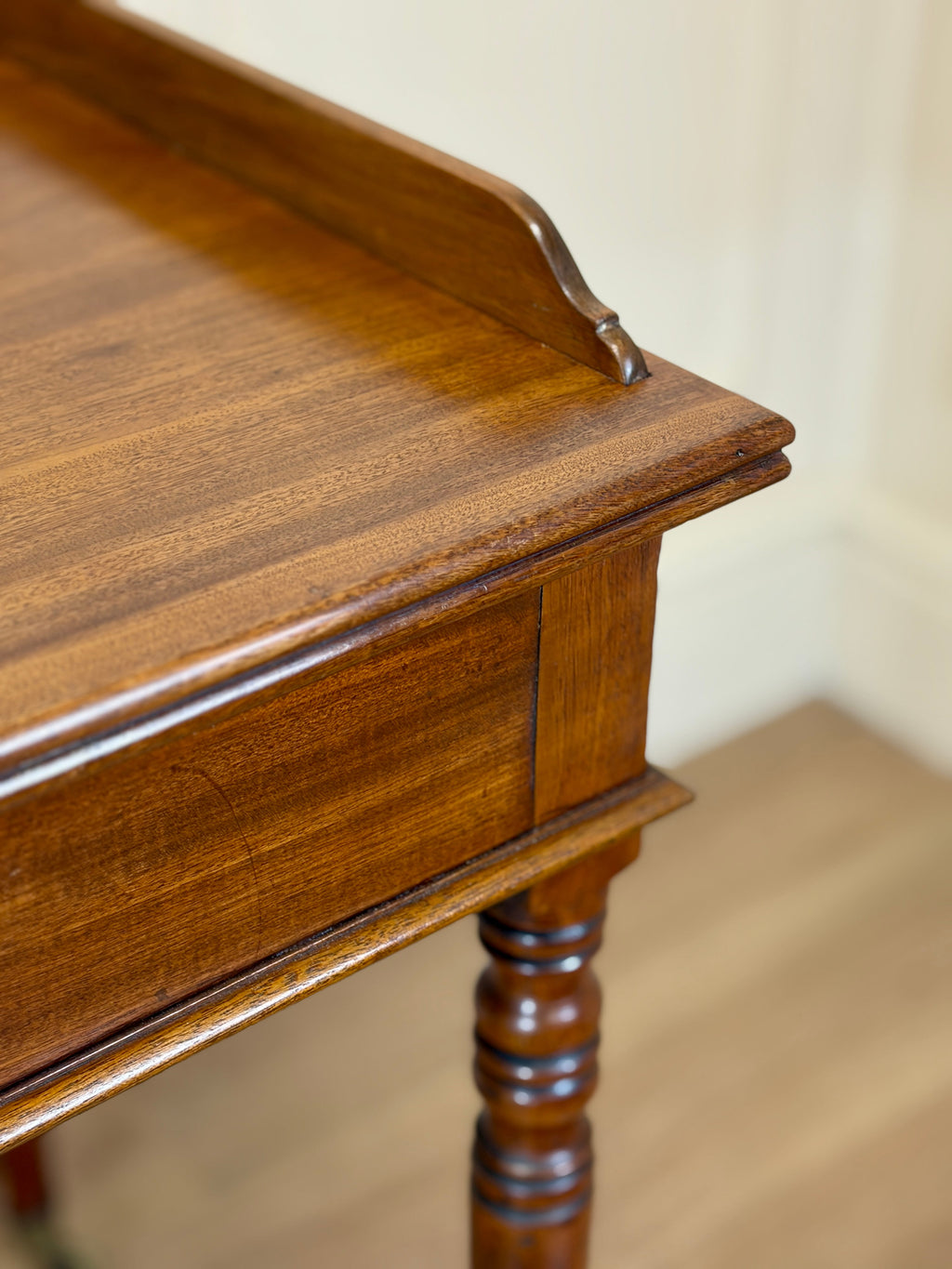 Close-up of a wooden side table with a plain background