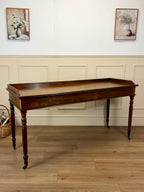 Wooden console table against a wall with decorative elements