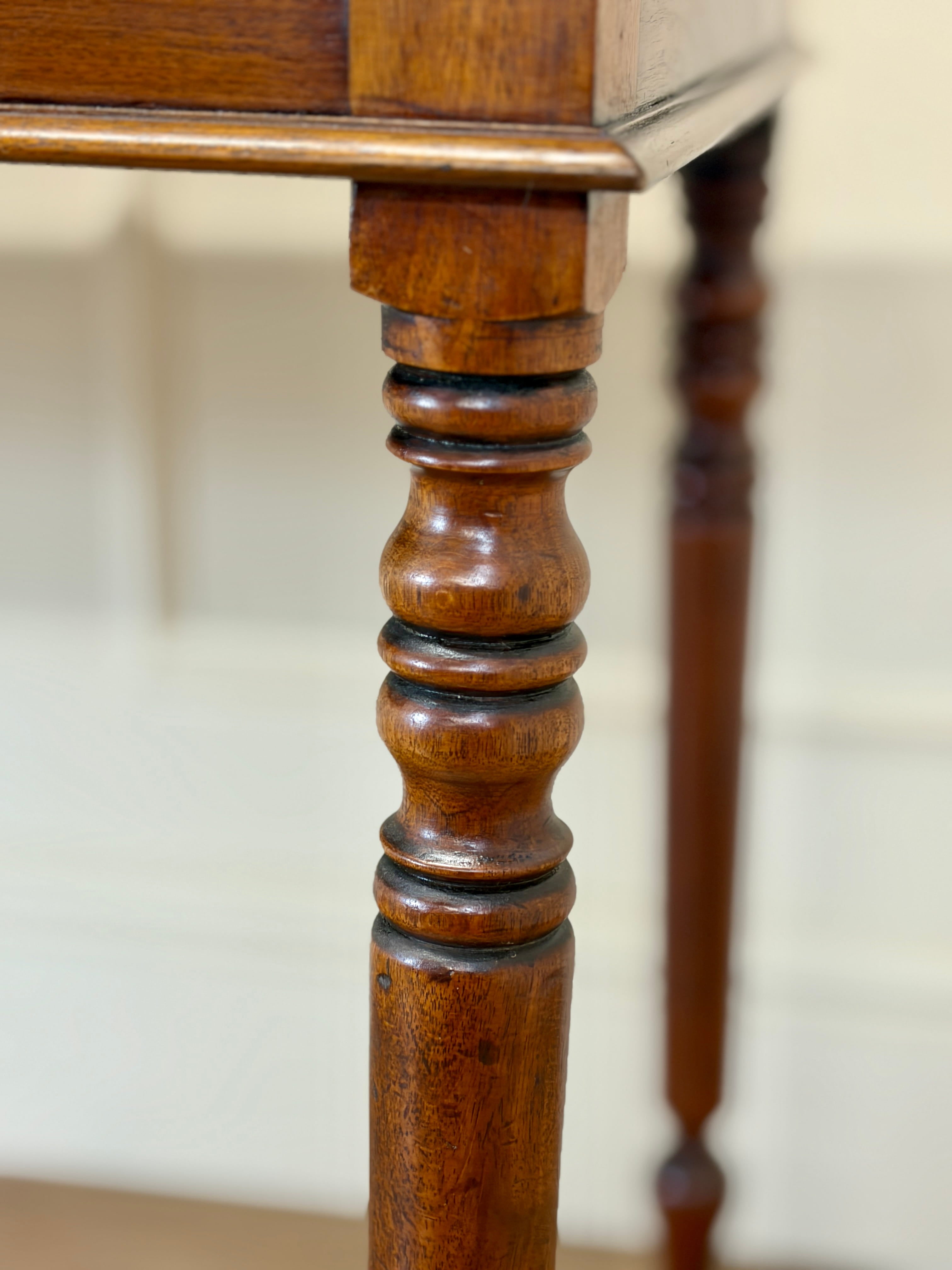 Close-up of a wooden table leg with a white background