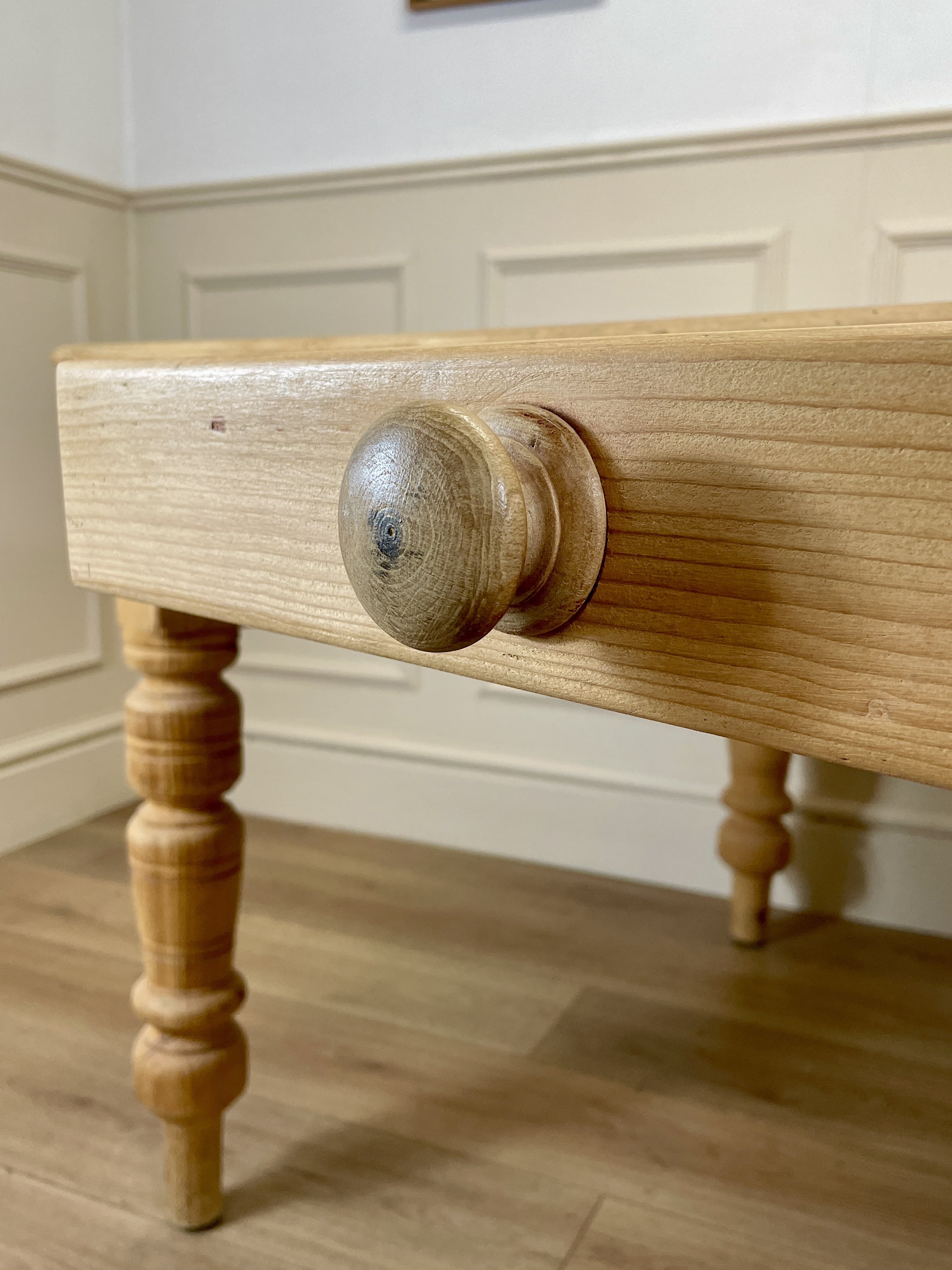 Wooden drawer with a knob on a wooden floor.