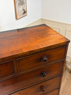 Wooden dresser with three drawers in a room setting