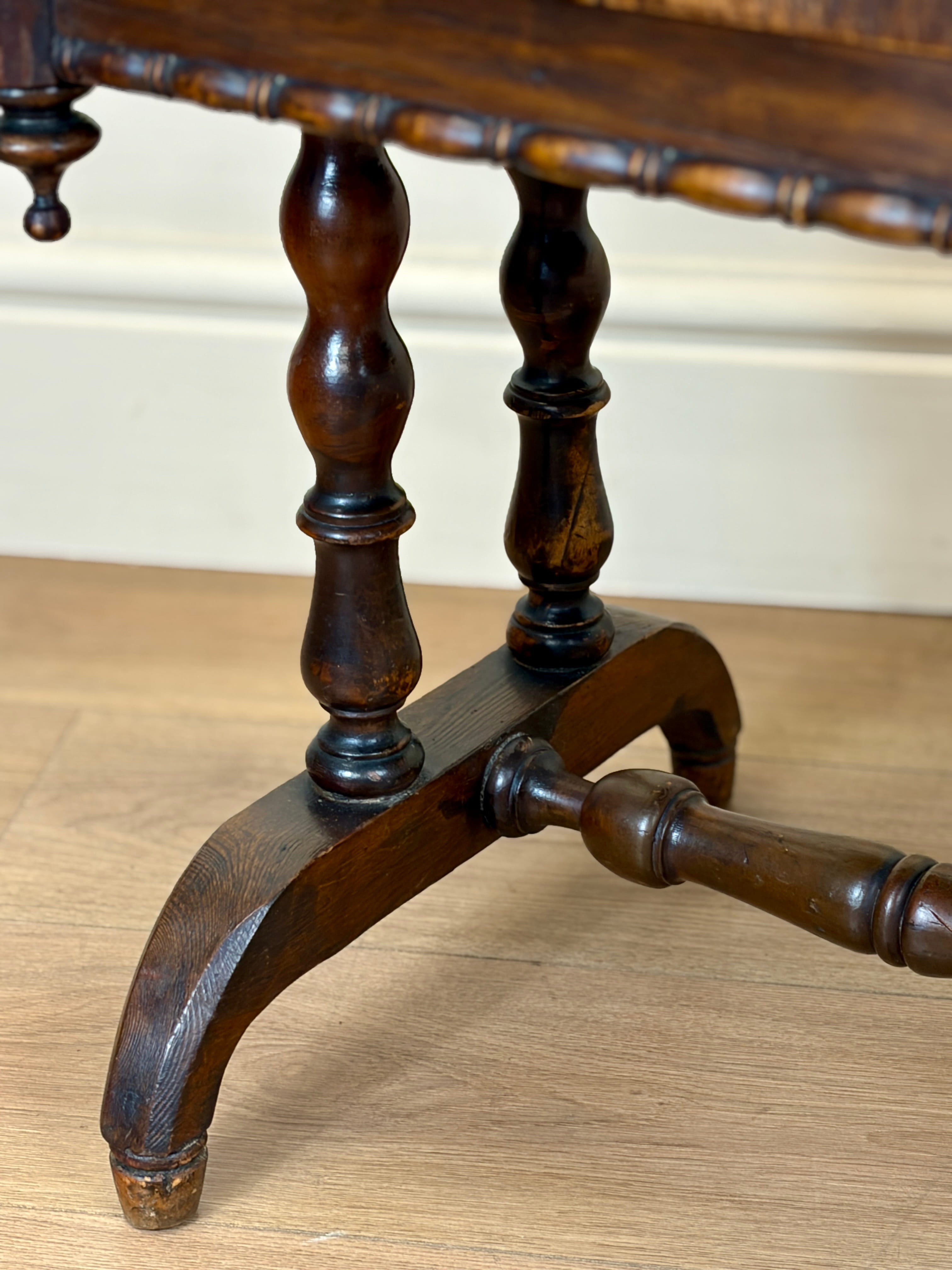 Close-up of a wooden table leg on a light wood floor.