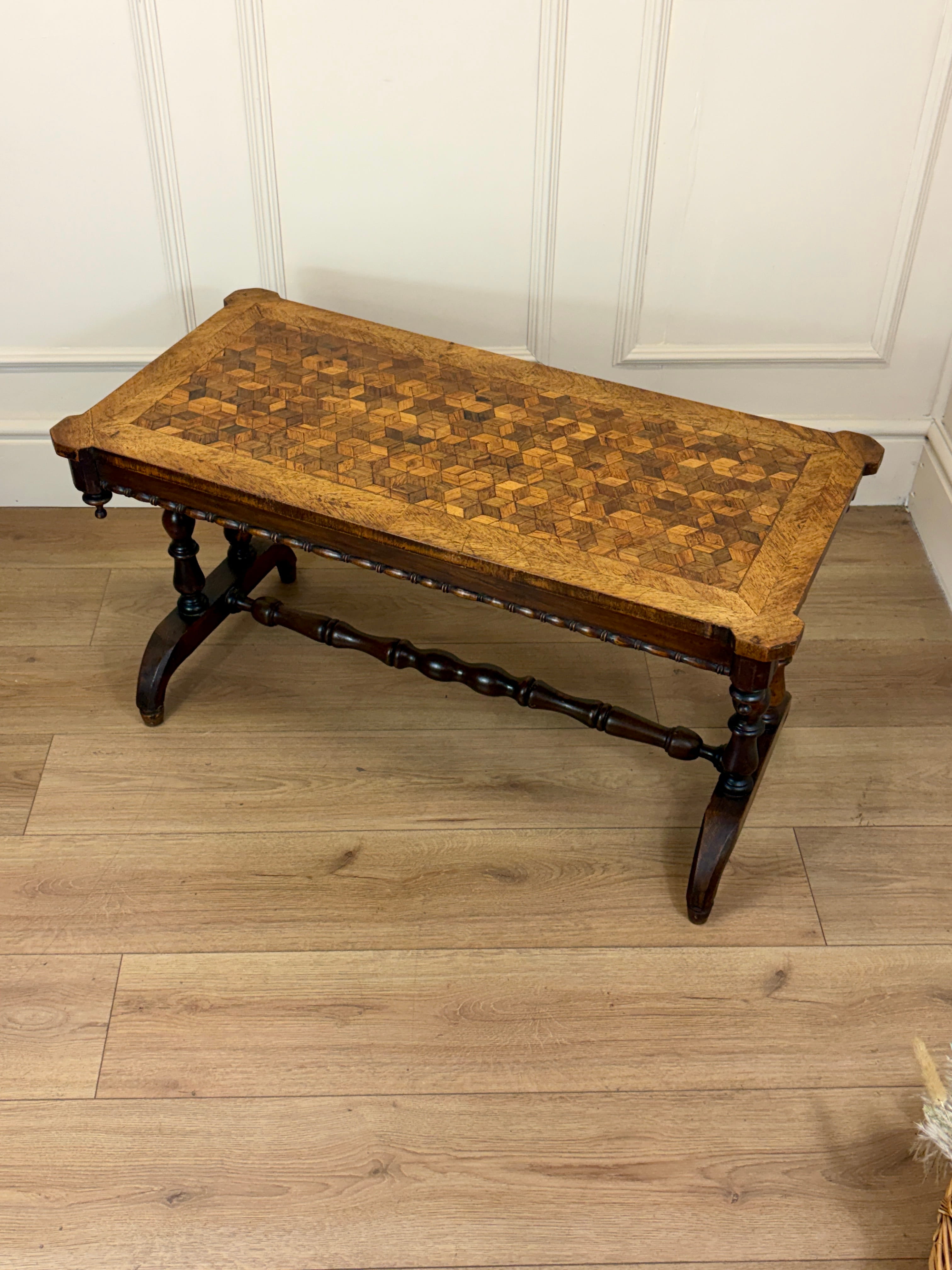 Wooden bench with a checkered top on a wooden floor