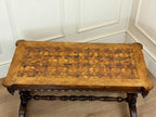 Wooden table with geometric pattern against a white paneled wall