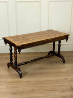 Wooden table with a checkered surface on a wooden floor against a white paneled wall.