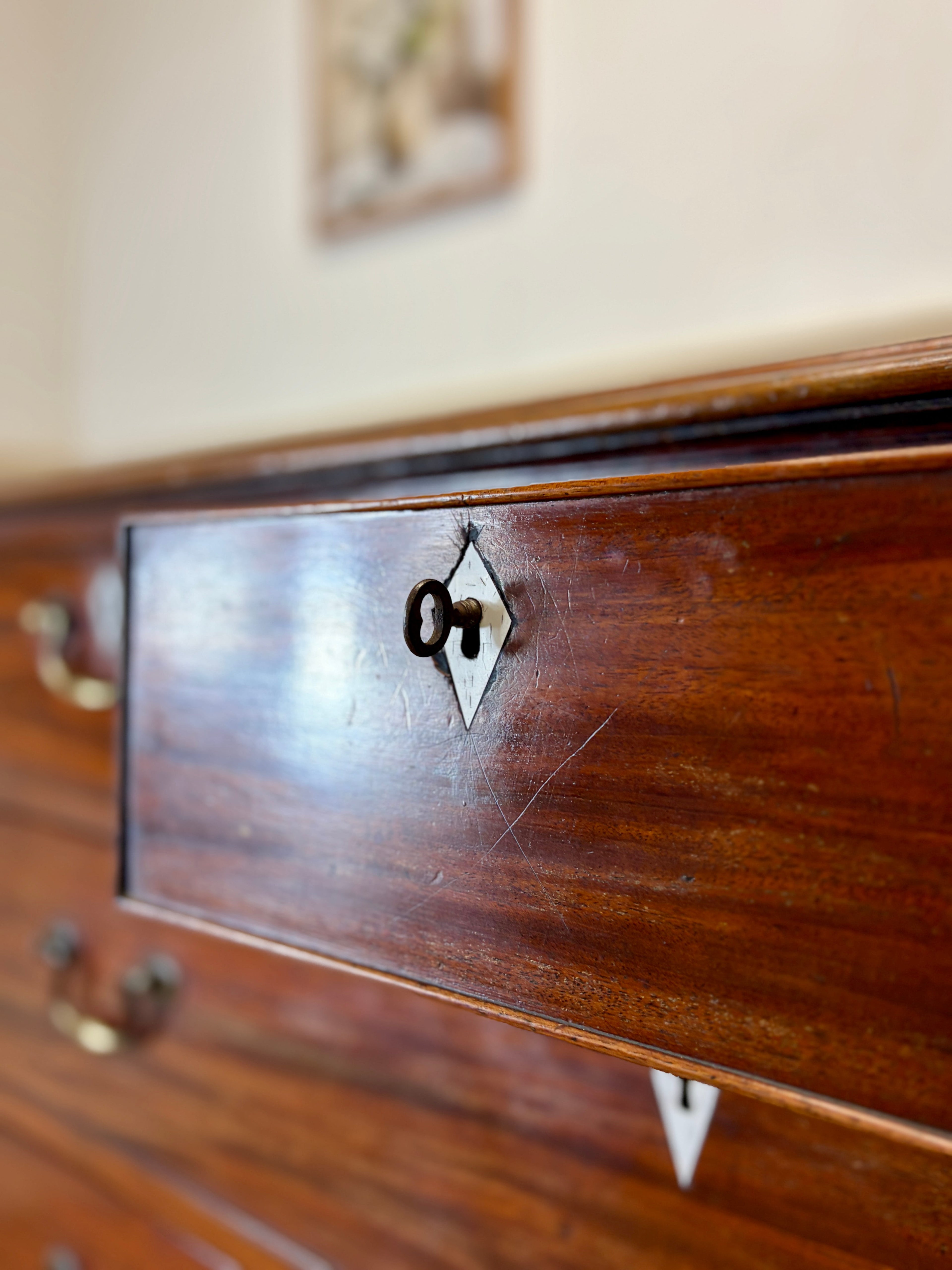 Wooden drawer with a decorative emblem on a blurred background