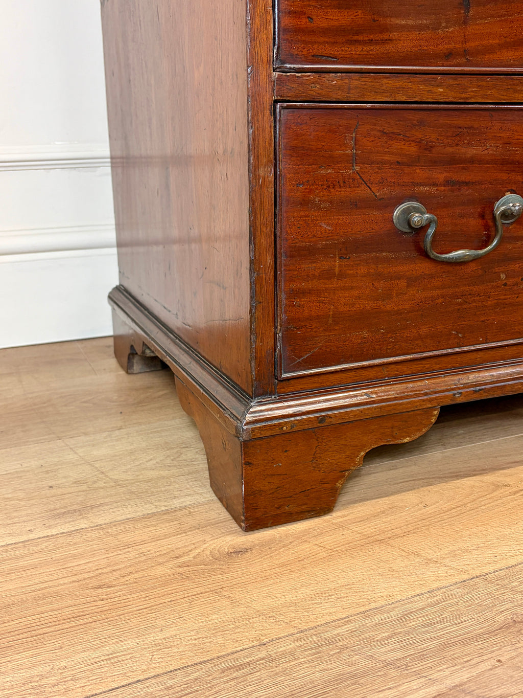 Wooden dresser with a drawer on a wooden floor